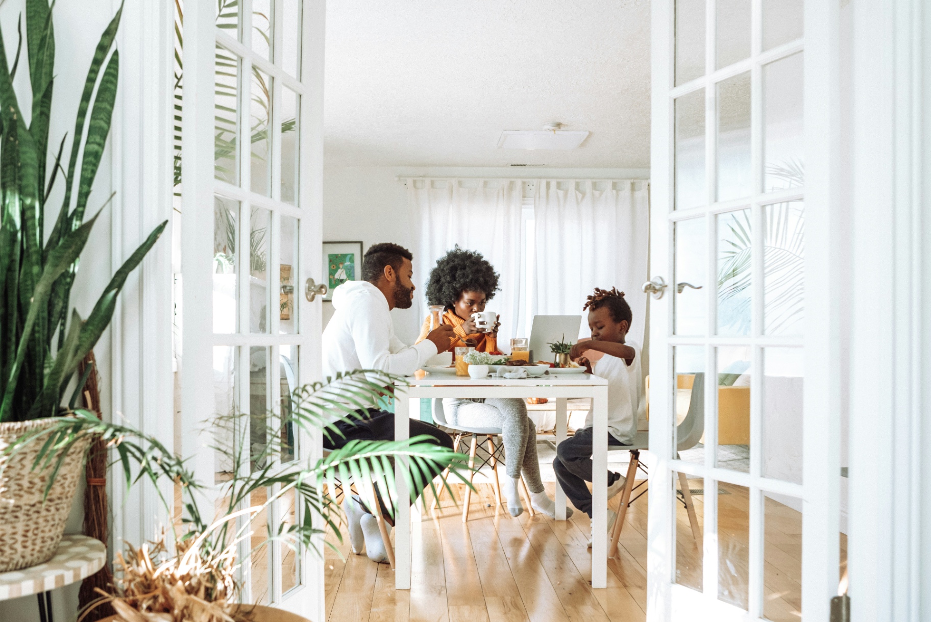A family sharing a meal in their own home.
